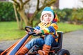 Active cute boy having fun with toy race cars Royalty Free Stock Photo