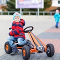 Active cute boy having fun with toy race cars Royalty Free Stock Photo