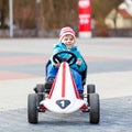 Active cute boy having fun with toy race cars Royalty Free Stock Photo