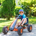 Active cute boy having fun with toy race cars Royalty Free Stock Photo