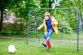 Active cute little kid boy playing soccer and football and having fun Royalty Free Stock Photo