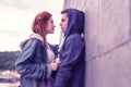 Resolute long-haired ginger girl attentively looking on her boyfriend