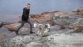 Active Dog Walker on Rocky Shore Royalty Free Stock Photo