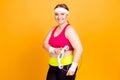 Active dynamic sportive lifestyle concept. Cheerful pretty excited confident fatty lady wearing sporty outfit is holding glassy e