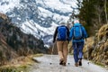 Active elderly couple walking down mountain road Royalty Free Stock Photo