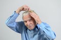 Active elderly man combing his hair with a comb Royalty Free Stock Photo