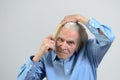 Active elderly man combing his hair with a comb Royalty Free Stock Photo