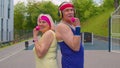 Active elderly old sports team grandmother grandfather weightlifting dumbbells, smiling at camera