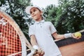 Active exercise for kids on tennis court. Portrait of sporty little girl on tennis court. Summer activities for children.Child Royalty Free Stock Photo