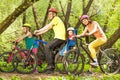 Active family on bikes riding in sunny forest Royalty Free Stock Photo