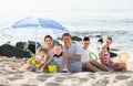 Active family with children together on beach sitting Royalty Free Stock Photo