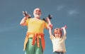 Active family enjoy sport and fitness. Funny old senior man and kid boy with dumbbells. Grandfather and child do morning Royalty Free Stock Photo