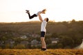 Active family. Father and daughter have fun together. Dad throws daughter up in sky. Royalty Free Stock Photo