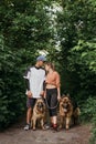Active Family, fitness couple, Pet Love, Dog Training, best dog breeds for family. Young sports couple walking with two Royalty Free Stock Photo