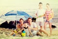 Active family with kids together on beach sitting Royalty Free Stock Photo