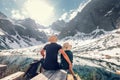 Active family leisure, spring summer hiking. Father and son rest near the mountain lake Royalty Free Stock Photo