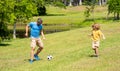 Active father son playing football in summer. Father and child son teaming up outdoor. Father dad and son enjoying Royalty Free Stock Photo