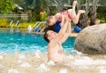 Active father teaching his toddler daughter to swim in pool on tropical resort Royalty Free Stock Photo