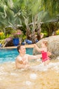 Active father teaching his toddler daughter to swim in pool on tropical resort. Royalty Free Stock Photo