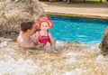 Active father teaching his toddler daughter to swim in pool on tropical resort. Royalty Free Stock Photo