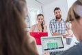 Active female entrepreneur talking on mobile at a shared desk