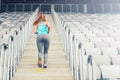 Active female runner enjoying a workout, training and working out. Fitness girl jogging on stairs