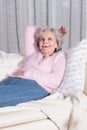 Active female senior relaxing on couch