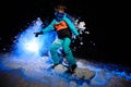 Active female snowboarder dressed in a orange and blue sportswear riding on the snow Royalty Free Stock Photo