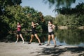 Active Females Enjoying Pre-Workout Stretching Exercises in a Sunny City Park. Royalty Free Stock Photo