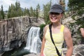 Active fit female hiker poses by Rainbow Falls in the Devils Postpile National Monument in California Royalty Free Stock Photo