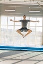 Active fit man doing yoga while jumping. flying lotus position. flying yoga pose