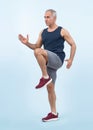 Active and fit senior man in sportswear portrait in running posture. Clout Royalty Free Stock Photo