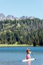 Active fit red head ginger woman kneeling on a Stand up paddleboard Royalty Free Stock Photo