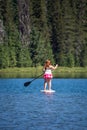 Active fit woman on a Stand up paddleboard boating on Todd Lake Oregon Royalty Free Stock Photo