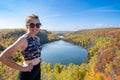 Active fit woman wearing athleisure clothing poses at the top of Bean and Bear Lake along the Superior Hiking Trail in fall