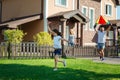 Cute girl launching a kite with her father in yard