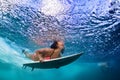 Active girl in bikini in dive action on surf board Royalty Free Stock Photo