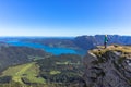 Active girl having a rest on the peak of Alps, Austria.Backpacker enjoying view of mountain panorama and lake.Hiking on Royalty Free Stock Photo