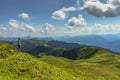 Active girl having a rest on the peak of Alps, Austria,Europe.Backpacker enjoying view of mountain panorama.Hiking on bright sunny Royalty Free Stock Photo