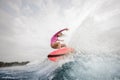 Active girl jumping on the orange wakeboard Royalty Free Stock Photo