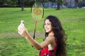 Active girl playing badminton in outdoor court in summer Royalty Free Stock Photo