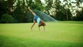 Active girl running in field. Cute kid doing cartwheel in meadow Royalty Free Stock Photo