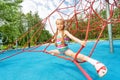 Active girl sits on red ropes in leg-split Royalty Free Stock Photo