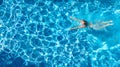 Active girl in swimming pool aerial drone view from above, young woman swims in blue water, tropical vacation, holiday on resort