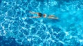 Active girl in swimming pool aerial drone view from above, young woman swims in blue water, tropical vacation, holiday on resort Royalty Free Stock Photo