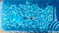 Active girl in swimming pool aerial drone view from above, young woman swims in blue water, tropical vacation, holiday on resort Royalty Free Stock Photo