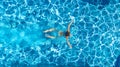 Active girl in swimming pool aerial drone view from above, young woman swims in blue water, tropical vacation, holiday on resort Royalty Free Stock Photo