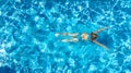 Active girl in swimming pool aerial drone view from above, young woman swims in blue water, tropical vacation Royalty Free Stock Photo