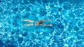 Active girl in swimming pool aerial drone view from above, young woman swims in blue water, tropical vacation, holiday on resort Royalty Free Stock Photo