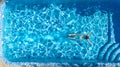 Active girl in swimming pool aerial drone view from above, young woman swims in blue water, tropical vacation, holiday on resort Royalty Free Stock Photo